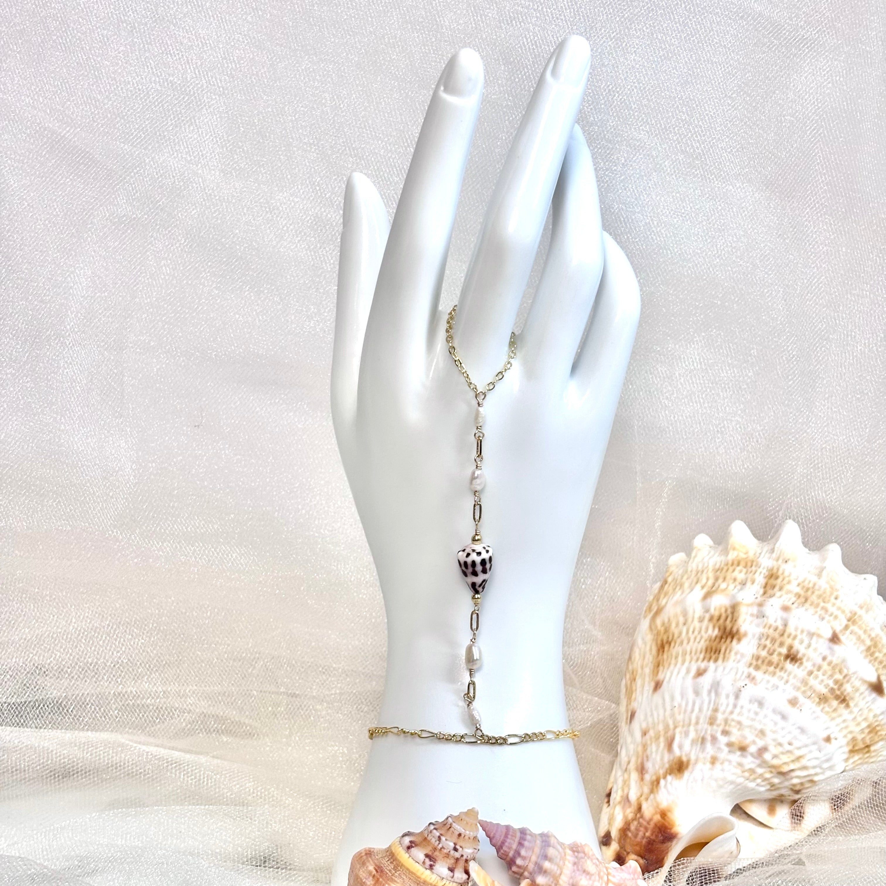 Hebrew cone shell handchain w/ white pearls