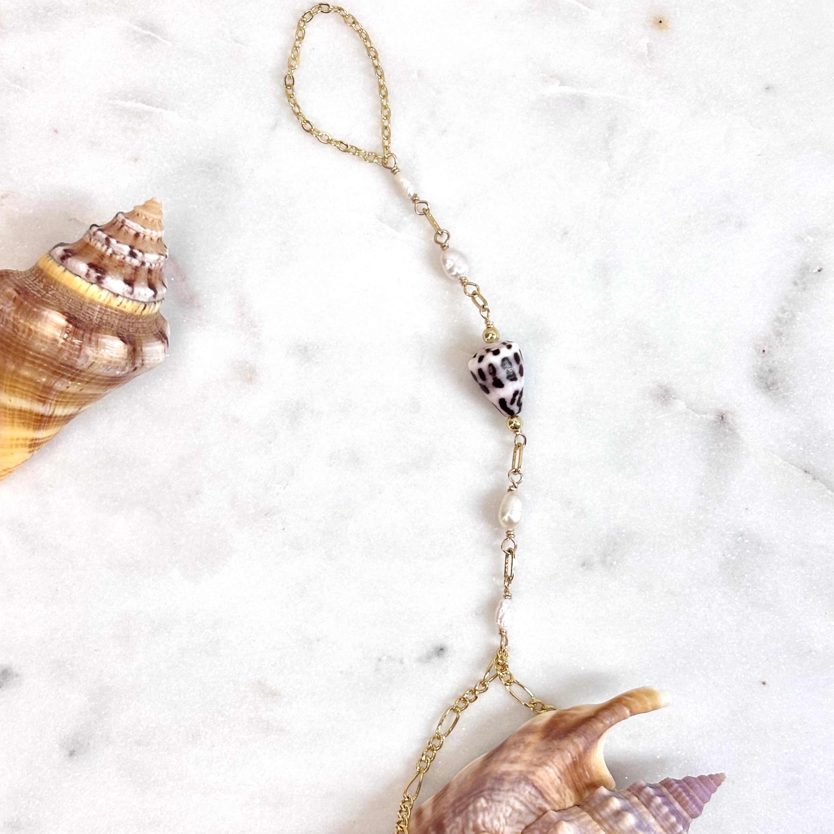 Hebrew cone shell handchain w/ white pearls
